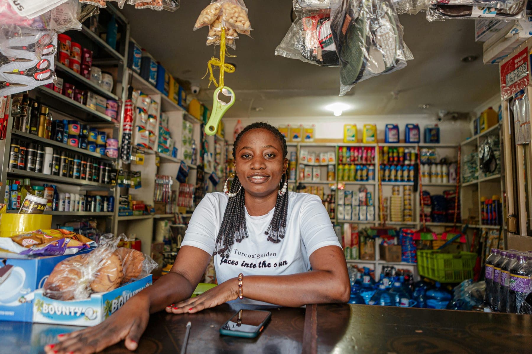 Commerçante derrière le comptoir de sa boutique d'alimentation générale